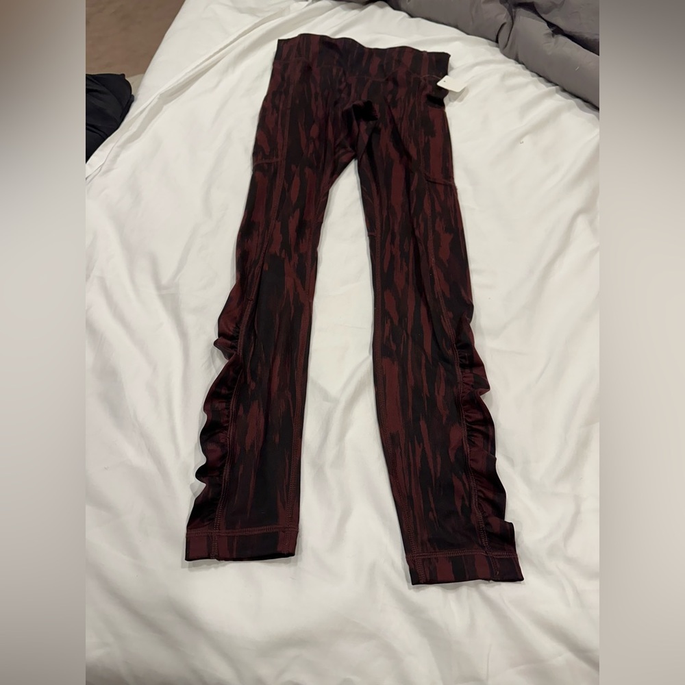 Excellent condition like new Lululemon Lan leggings size 4 black and burgundy